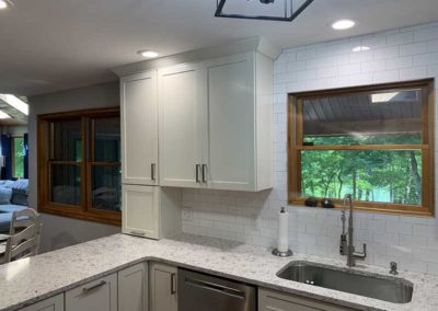 White countertop and cabinets by Mountaineer Kitchens and Baths