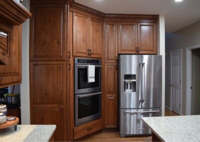 Wooden kitchen cabinets and stainless steel appliances by Mountaineer Kitchens and Baths