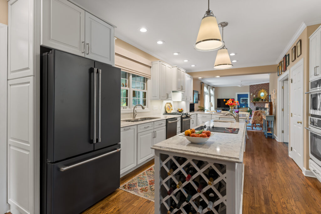 kitchen island with black refrigerator