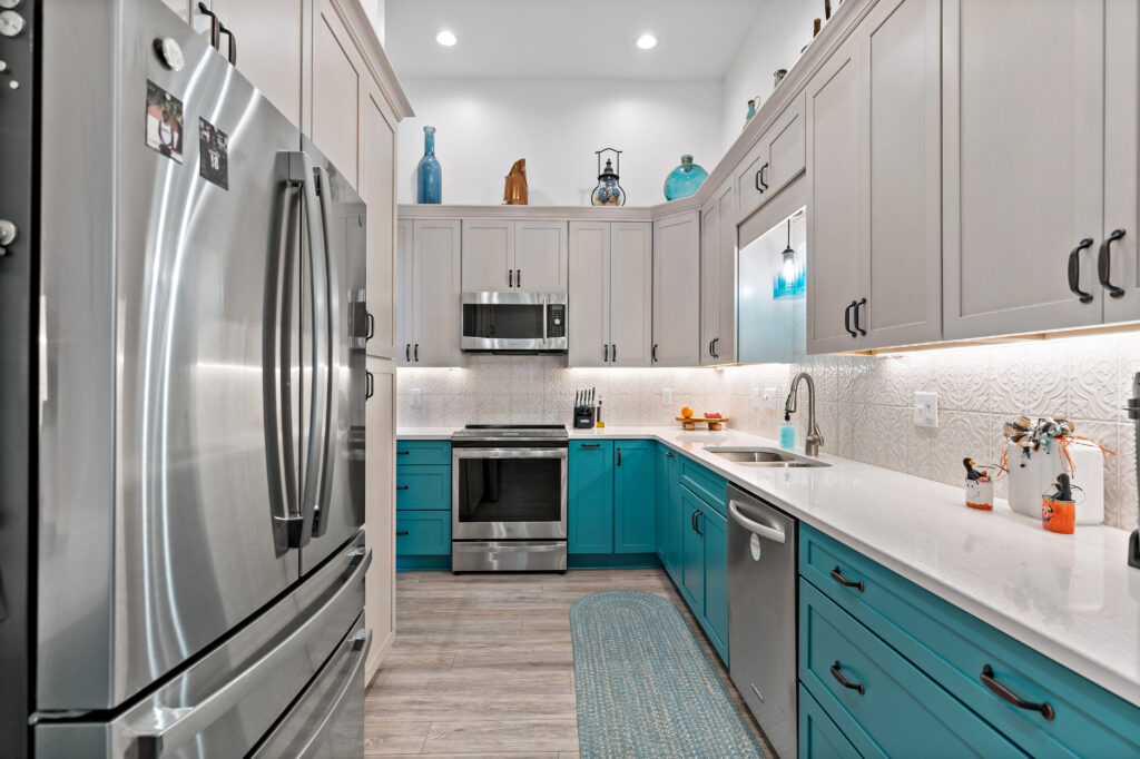 modern kitchen with blue cabinets and stainless steel fridge