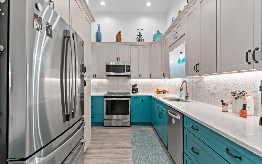 modern kitchen with blue cabinets and stainless steel fridge