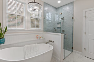 bathroom with white bathtub and stand up shower