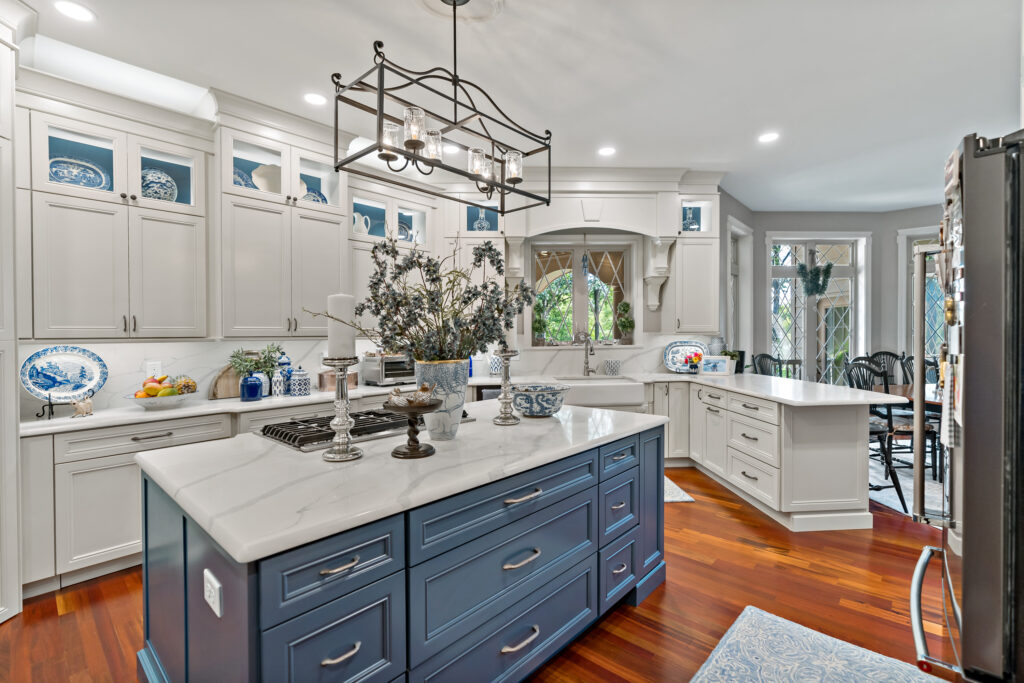 blue kitchen island with hardwood flooring and quartz countertops
