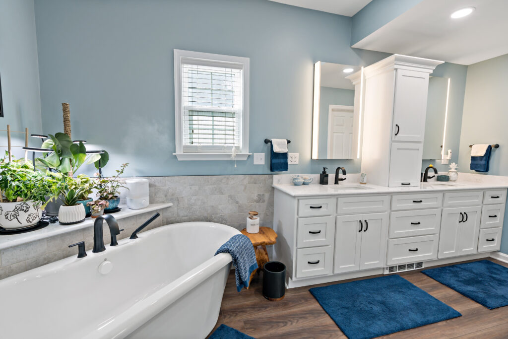 bathroom with custom cabinets and freestanding tub